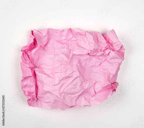 crumpled pink rectangular sheet of paper on a white background