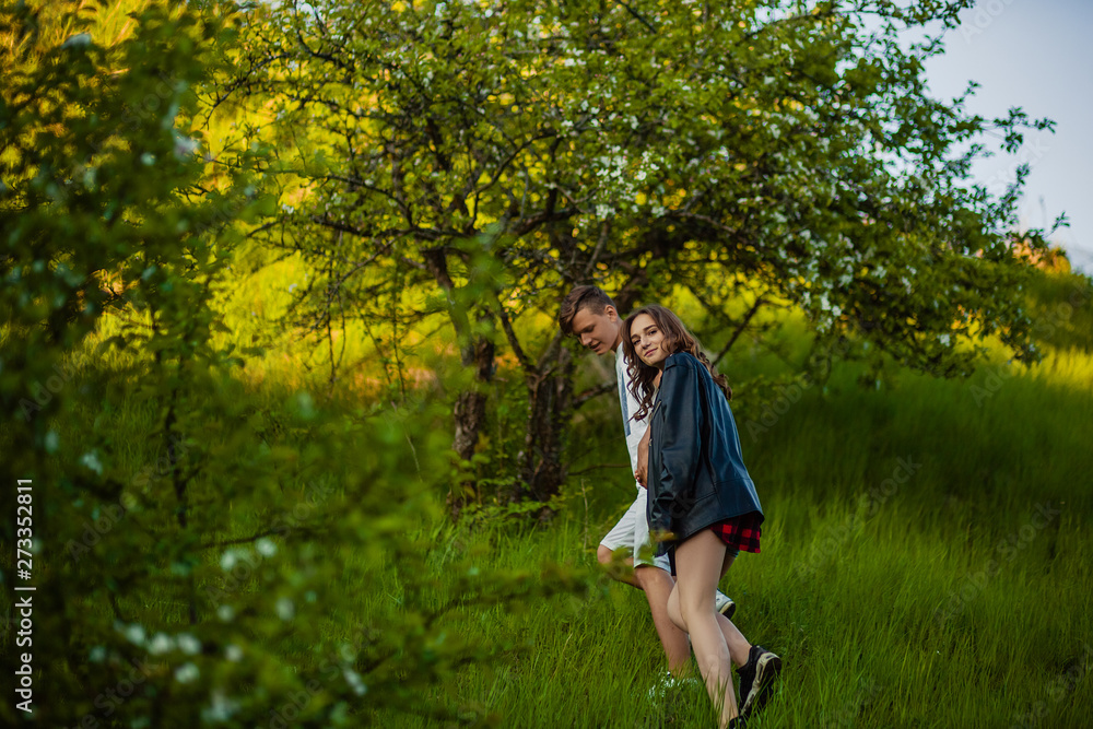 Beautiful couple walks in the woods Beautiful couple walks in the woods