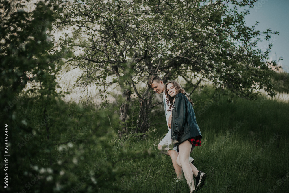 Beautiful couple walks in the woods Beautiful couple walks in the woods