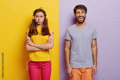 Konstfotografi Dissatisfied young woman keeps arms folded, offended after quarrel with boyfrien
