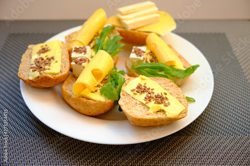 Fototapeta Naklejka Na Ścianę i Meble -  Fresh bread with cheese and basil for breakfast in a trip