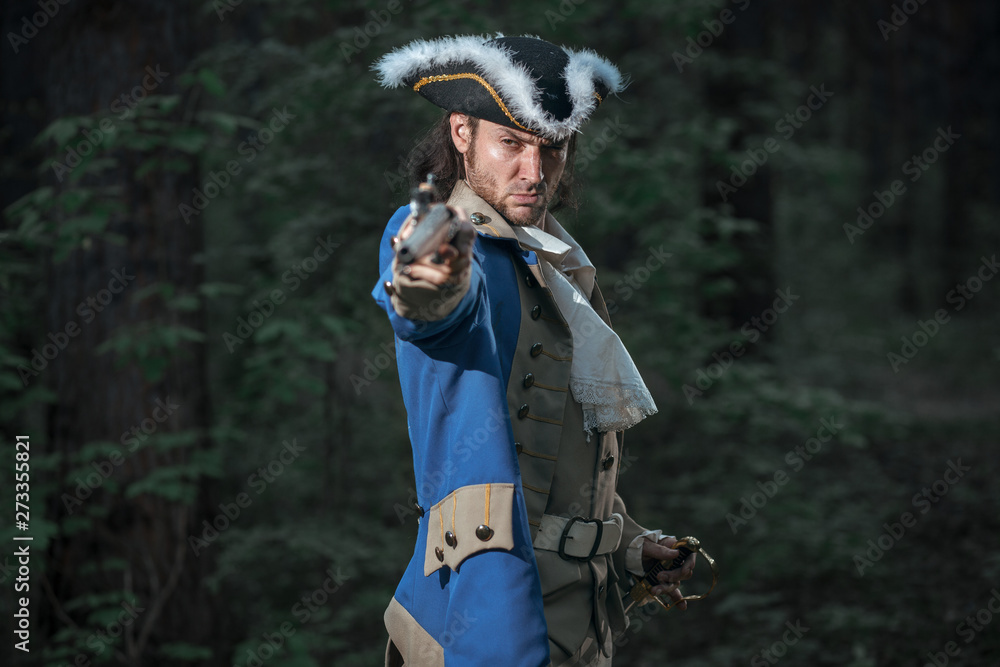 Portrait of man dressed as soldier of War of Independence United States aims from pistol with flag. 4 july independence day of USA concept photo composition: soldier and flag.