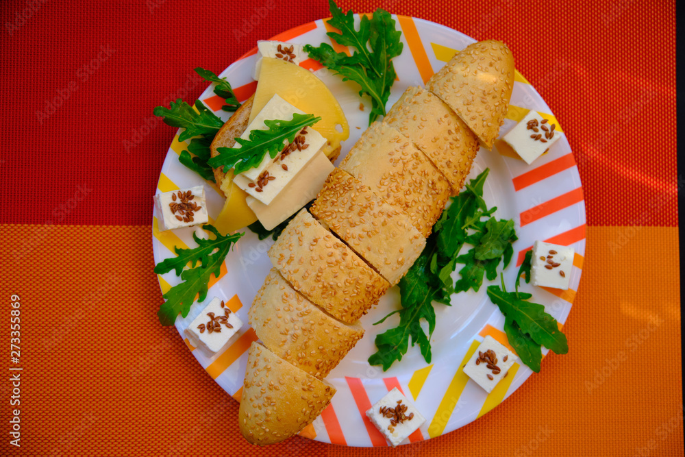 Fresh bread with cheese and basil for breakfast in a trip Fresh bread with cheese and basil for breakfast in a trip