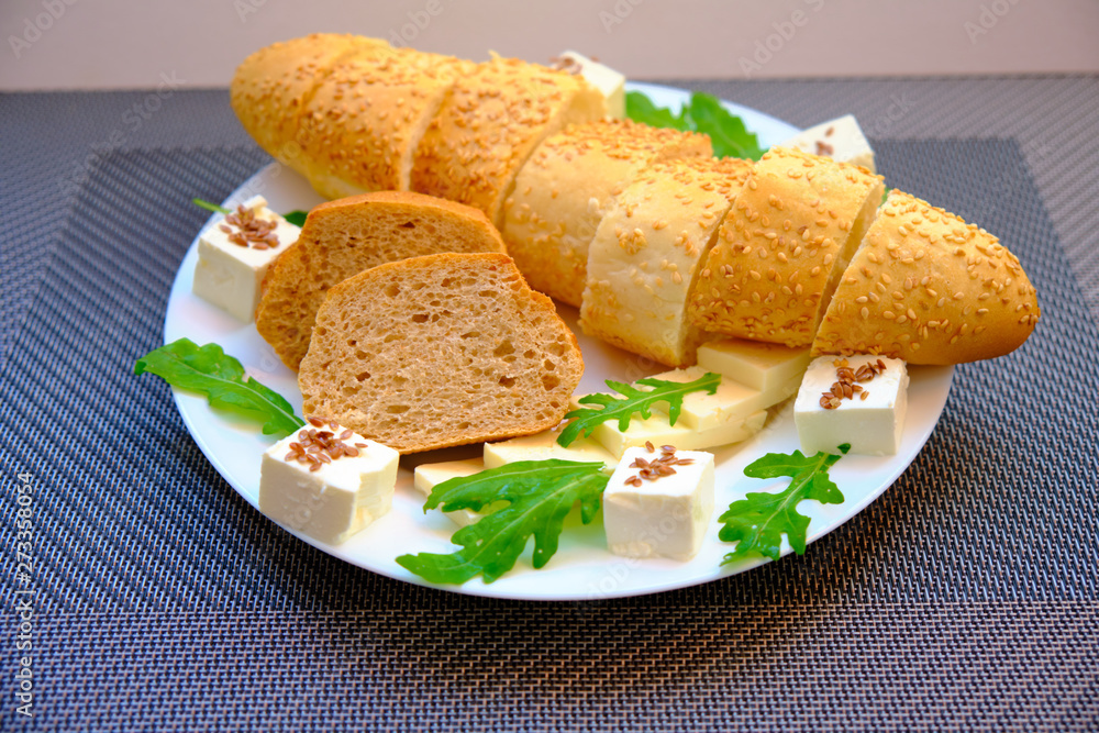Fresh bread with cheese and basil for breakfast in a trip Fresh bread with cheese and basil for breakfast in a trip