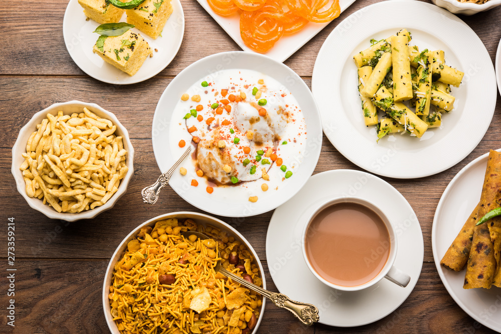 Group of Gujarati snacks like jalebi-fafda, thepla, khaman dhokla, aloo bhujiya, khandvi,khakra, dahi vada, gathiya with hot tea Group of Gujarati snacks like jalebi-fafda, thepla, khaman dhokla, aloo bhujiya, khandvi,khakra, dahi vada, gathiya with hot tea