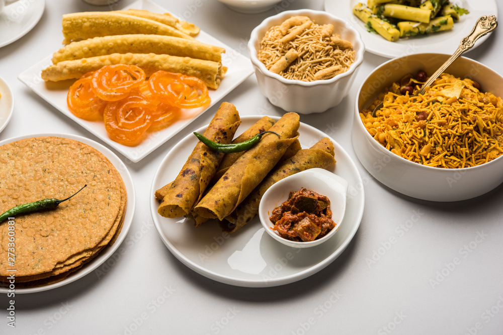 Group of Gujarati snacks like jalebi-fafda, thepla, khaman dhokla, aloo bhujiya, khandvi,khakra, dahi vada, gathiya with hot tea Group of Gujarati snacks like jalebi-fafda, thepla, khaman dhokla, aloo bhujiya, khandvi,khakra, dahi vada, gathiya with hot tea