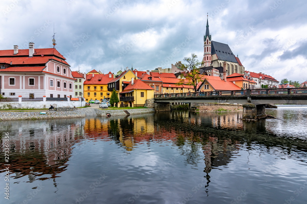 St. Vitus Church and Cesky Krumlov architecture reflected in Vltava river, Czech Republic