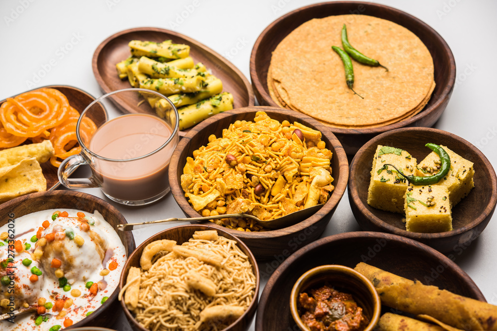 Group of Gujarati snacks like jalebi-fafda, thepla, khaman dhokla, aloo bhujiya, khandvi,khakra, dahi vada, gathiya with hot tea Group of Gujarati snacks like jalebi-fafda, thepla, khaman dhokla, aloo bhujiya, khandvi,khakra, dahi vada, gathiya with hot tea