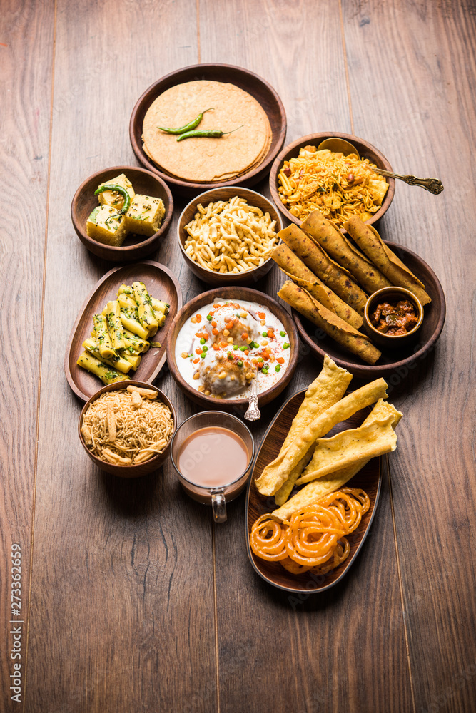 Group of Gujarati snacks like jalebi-fafda, thepla, khaman dhokla, aloo bhujiya, khandvi,khakra, dahi vada, gathiya with hot tea Group of Gujarati snacks like jalebi-fafda, thepla, khaman dhokla, aloo bhujiya, khandvi,khakra, dahi vada, gathiya with hot tea