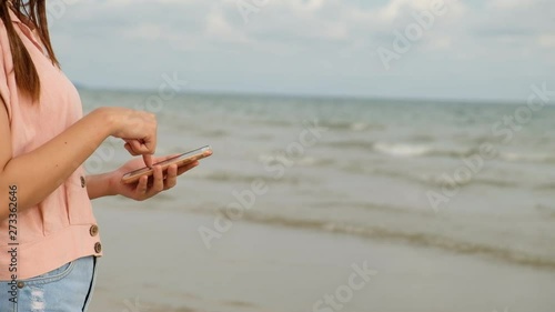 Close up, Woman use mobile phone on the beach, lifestyle and technology concept