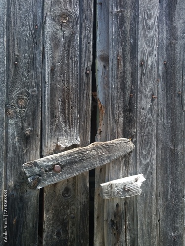 A close-up of a wooden latch of an old door.