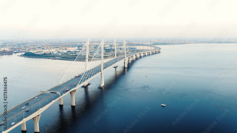 flycam moves above long cable-stayed bridge with pylons