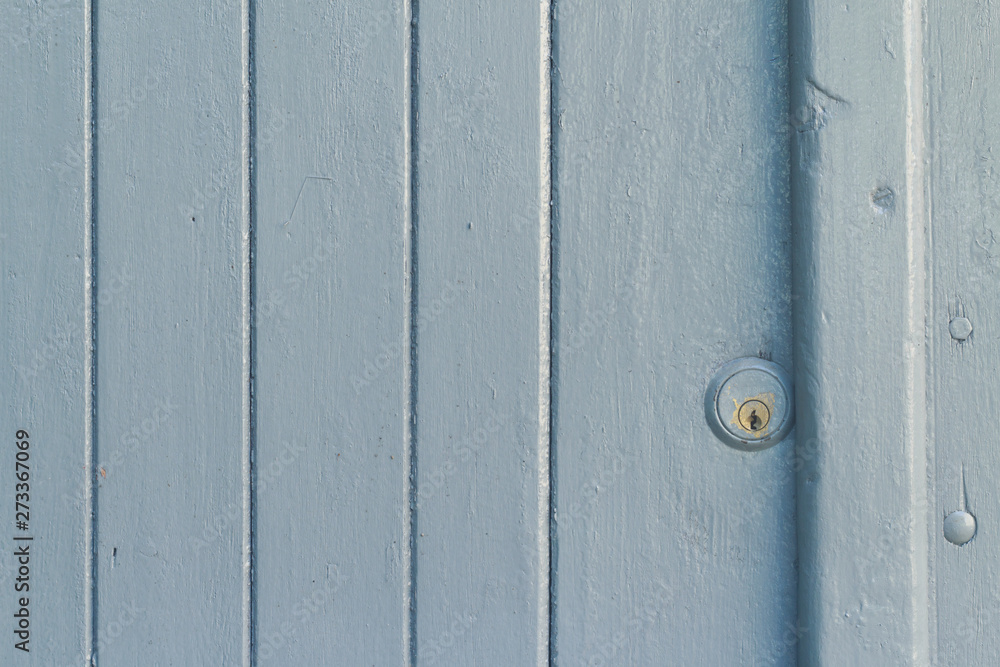 Wooden door painted in light blue with a small lock Wooden door painted in light blue with a small lock