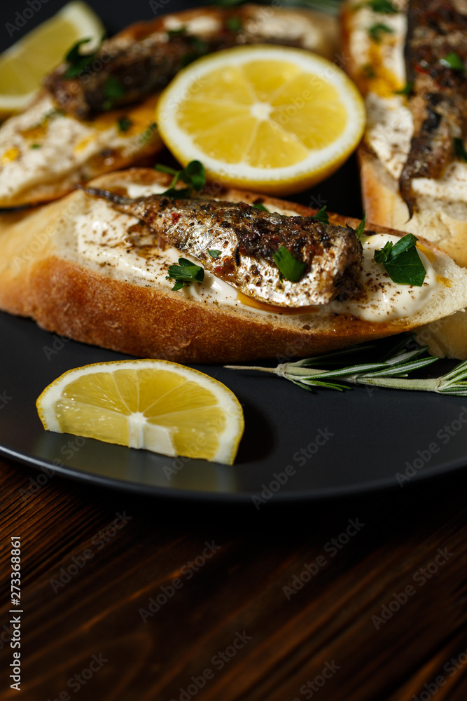 toast with sardines on a wood background closeup. top view toast with sardines on a wood background closeup. top view