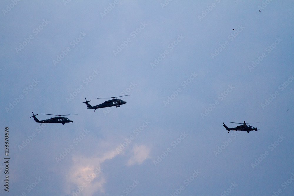 Military helicopters on blue sky with clouds and birds. Military helicopters on blue sky with clouds and birds.