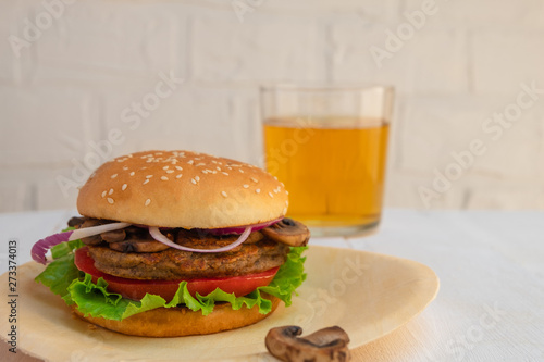 Veggie homemade mushroom and bean burger on white wooden background