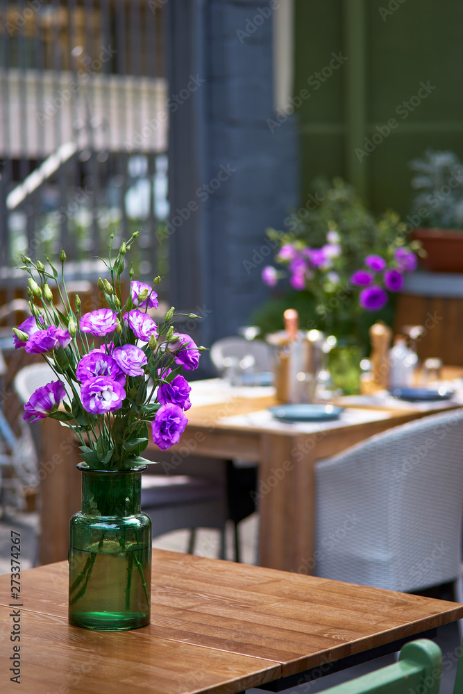 Terrace, tables decorated with flowers. the restaurant is waiting for visitors in the restaurant. Close up