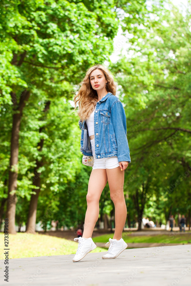 Beautiful sexy blonde woman dressed in a denim jacket and shorts Beautiful sexy blonde woman dressed in a denim jacket and shorts