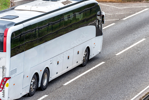 white bus coach on uk motorway in fast motion