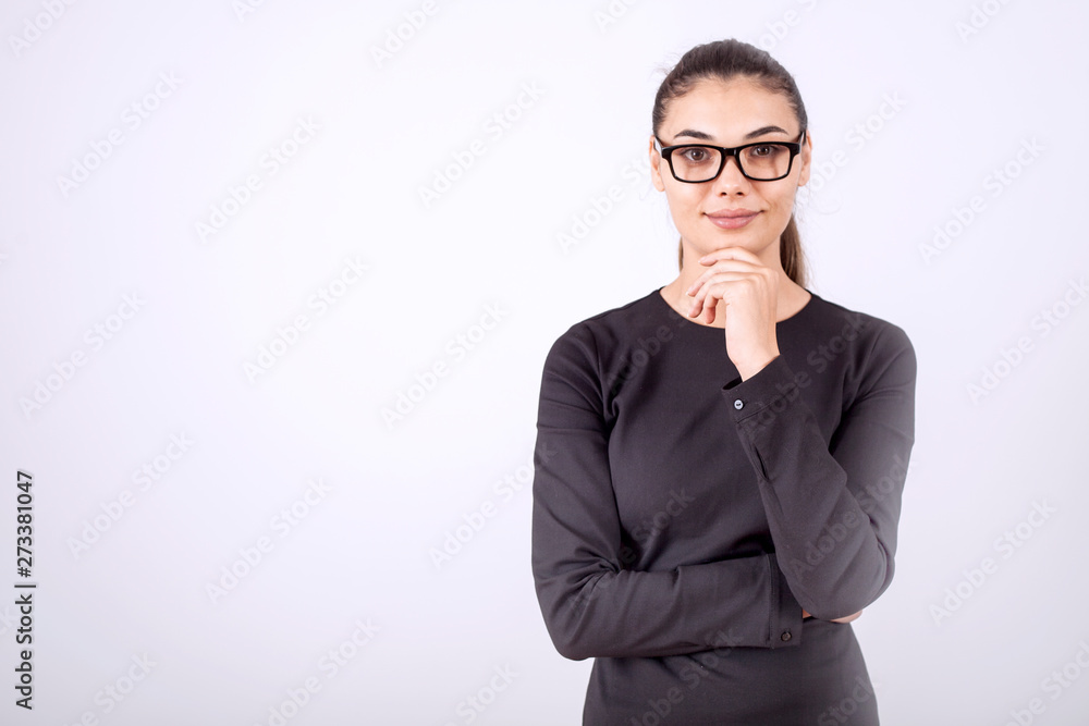 beautiful young businesswoman standing with crossed arms and smiling at camera in office beautiful young businesswoman standing with crossed arms and smiling at camera in office