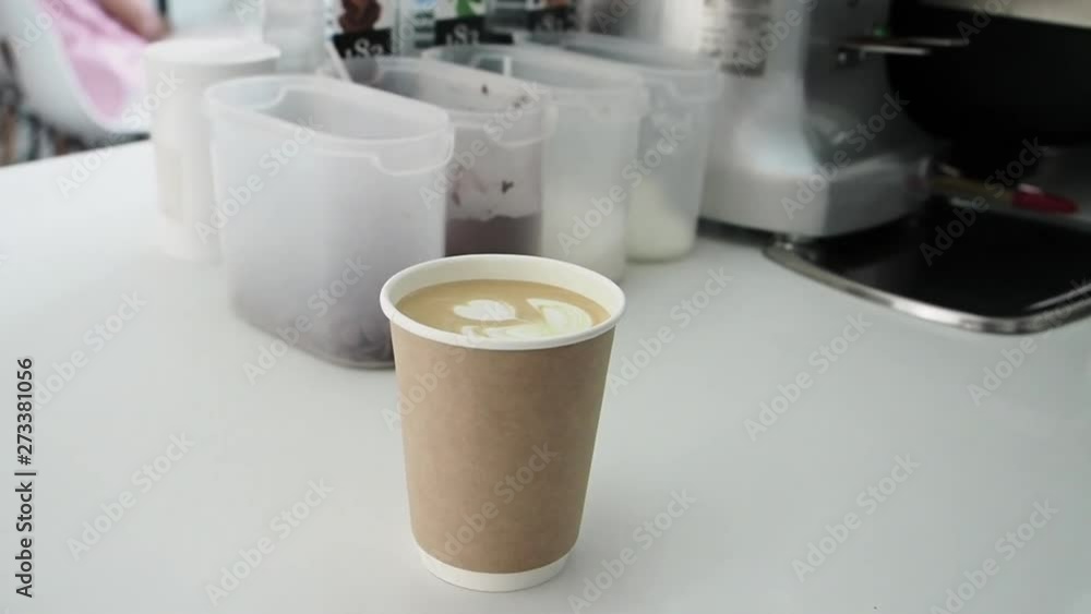 A glass of coffee latte standing on the bar. Slow Motion A glass of coffee latte standing on the bar. Slow Motion