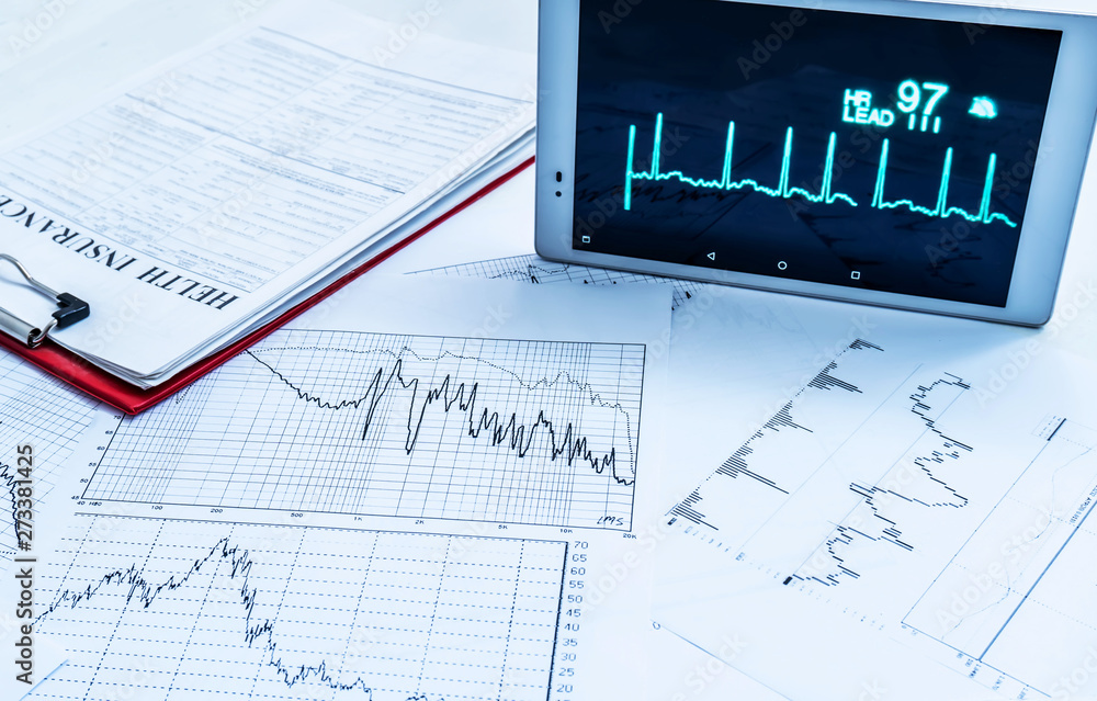 Medical concept. Health insurance blank and cardiogram computer expertise. Medical concept. Health insurance blank and cardiogram computer expertise.