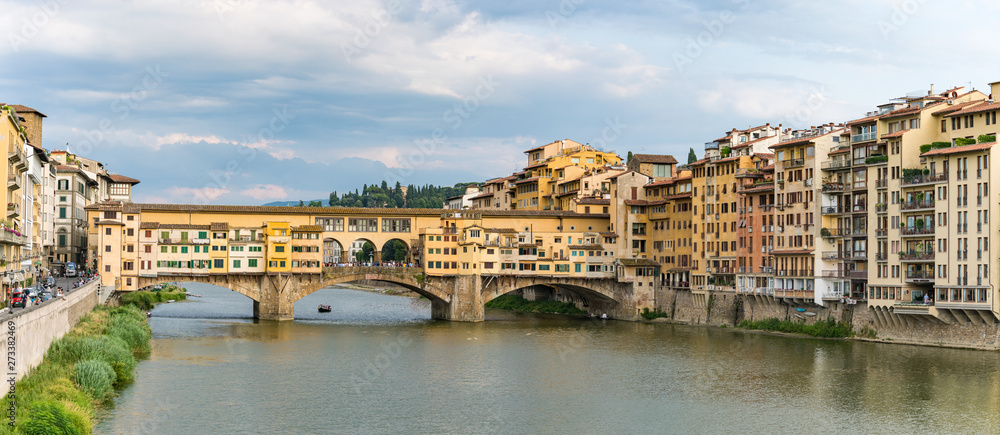 View of Arno River and medieval stone bridge Ponte Vecchio from the Ponte Santa Trinita in Florence, Tuscany, Italy