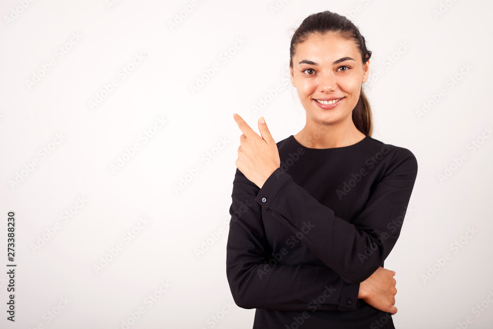 beautiful young businesswoman standing with crossed arms and smiling at camera in office beautiful young businesswoman standing with crossed arms and smiling at camera in office