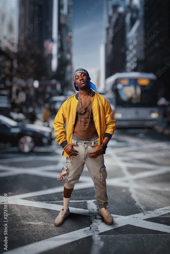 Black rapper on street, cityscape on background Black rapper on street, cityscape on background