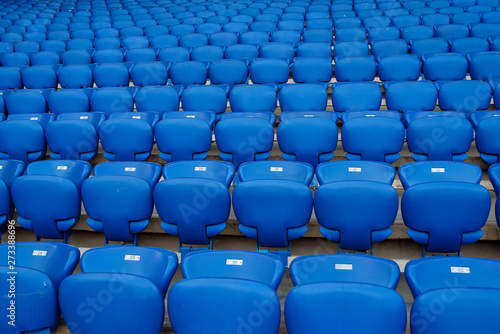 Rows of blue seats in the stand in the sports arena