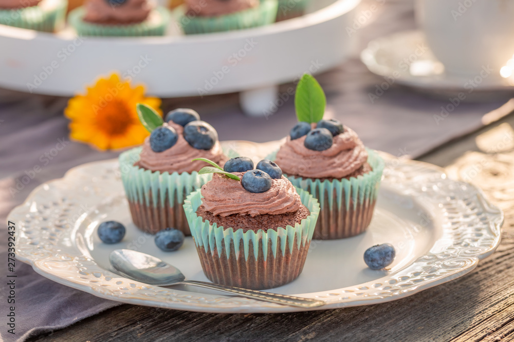 Closeup of brown cupcake made of cream and berries Closeup of brown cupcake made of cream and berries