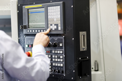 CNC machine operator working with a control panel