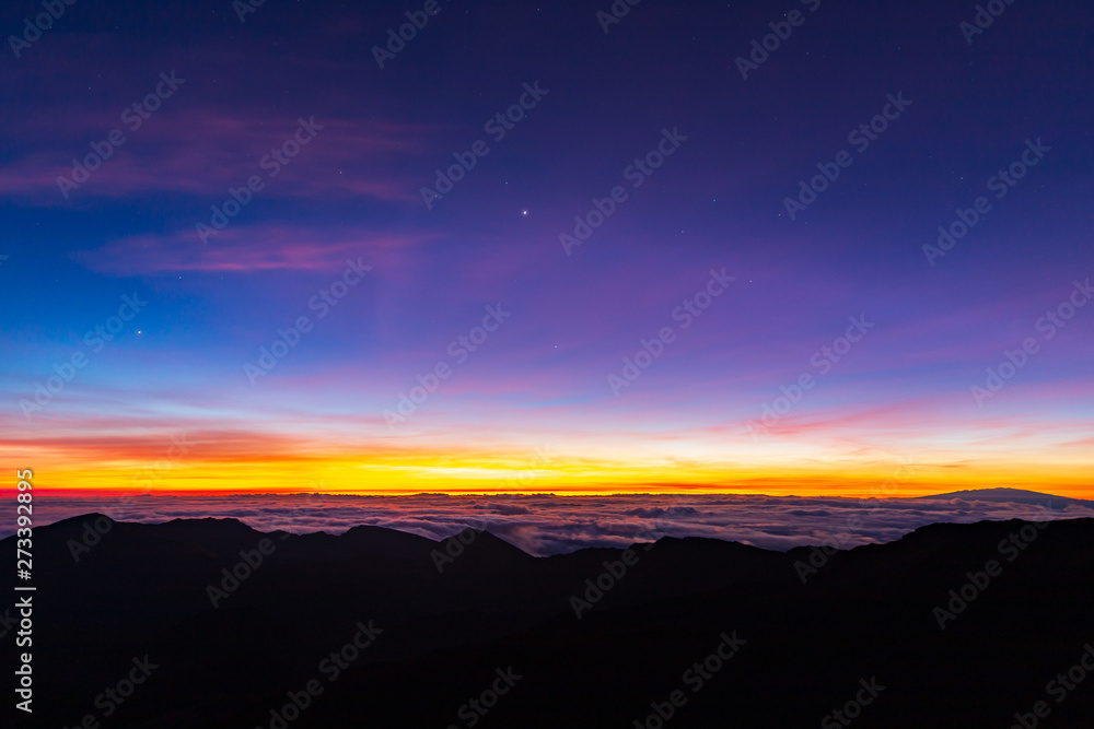 Beautiful and breathtaking sunrise at summit of Haleakala Crater in the National Park on the Hawaiian island of Maui, USA
