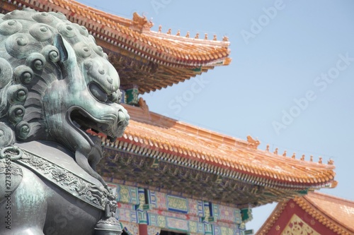 Chinese dragon (lion) statue in front of traditional Chinese building (Forbidden City, Beijing, China)