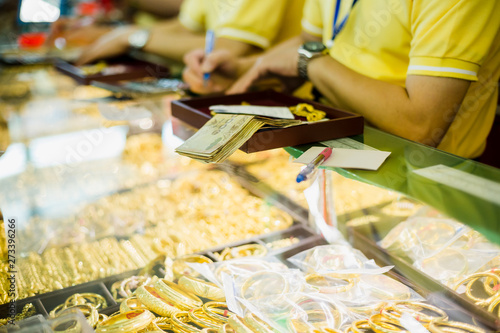 selective focus to banknote and staff with old jewelry.