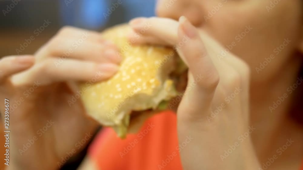 to close. woman with herpes on her lip eats french fries and hamburger to close. woman with herpes on her lip eats french fries and hamburger