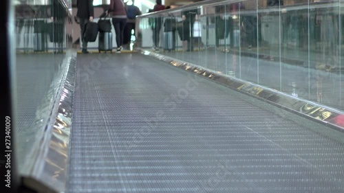 People on moving walkway at airport 4k photo