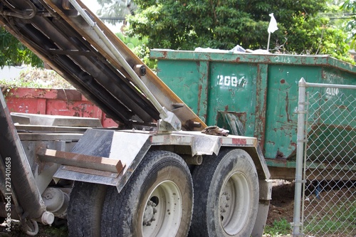 Dumpster at residential  construction site collected in roll-off  container for efficient disposal