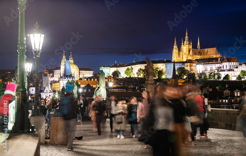 Charles bridge, famous landmark and travel destination in Prague, Czech Republic, with motion of crowded tourist walking around in summer