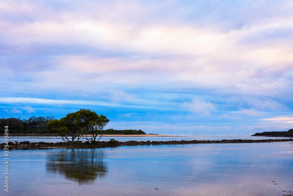 Landscape with colorful sky, ocean, trees and rocks, long exposure just after sunset shot at Urunga lagoon, Australia. Landscape with colorful sky, ocean, trees and rocks, long exposure just after sunset shot at Urunga lagoon, Australia.