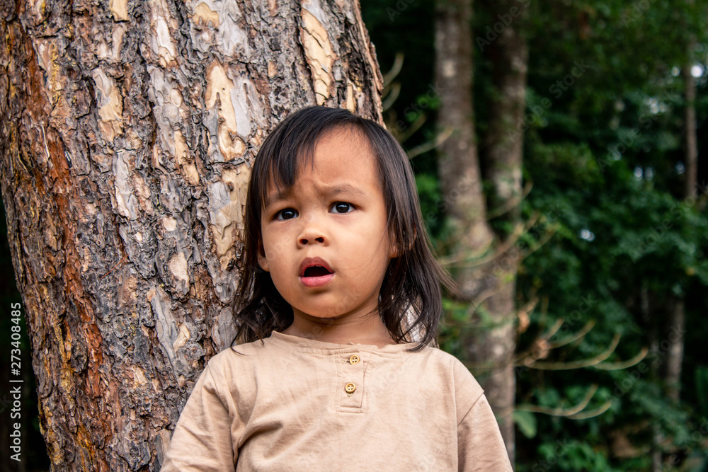 Asian little child girl shocked to see something in the garden. Playing is learning in children. Asian little child girl shocked to see something in the garden. Playing is learning in children.