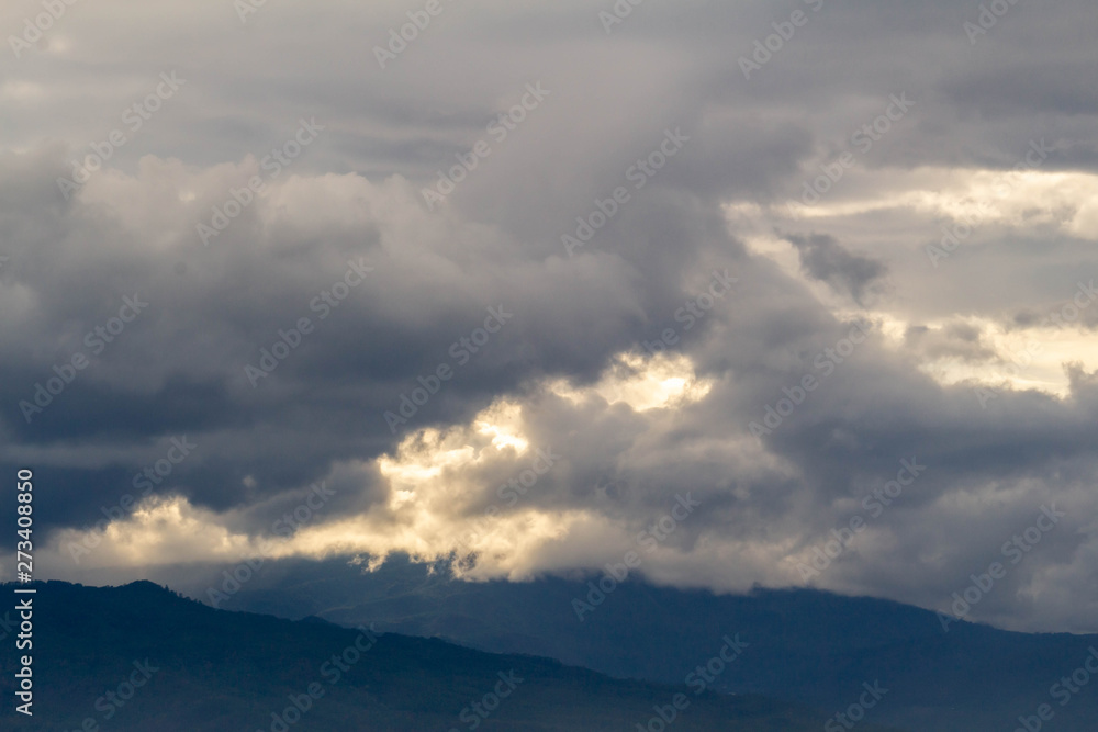 The Dark gray dramatic sky with large clouds on mountain in rainy seasons.