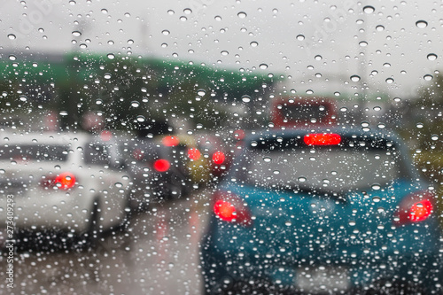 Street view through car window with rain.