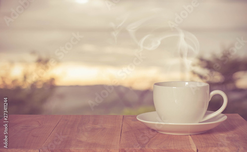 Coffee espresso on wood table nature background in garden,warm tone
