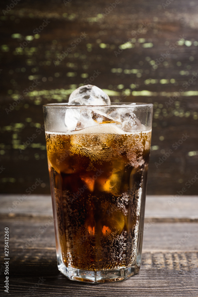 Refreshing cold cherry cola on the wooden background. Selective focus. Refreshing cold cherry cola on the wooden background. Selective focus.