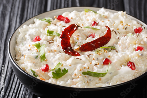 Thayir Saadam (Curd Rice) Recipe where  steamed rice and plain curd or with additional tempering of spices closeup in a plate. horizontal