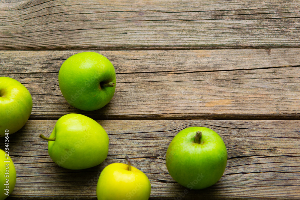 green apples on old wooden background green apples on old wooden background