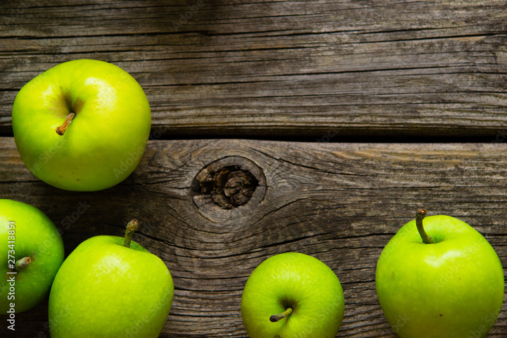 green apples on old wooden background green apples on old wooden background