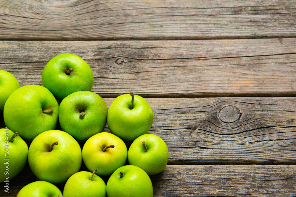 green apples on old wooden background green apples on old wooden background