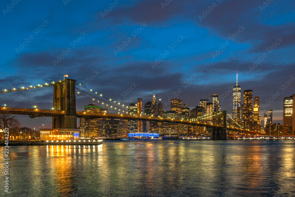 scene of New york Cityscape with Brooklyn Bridge over the east river at the twilight time, USA downtown skyline, Architecture and transportation concept